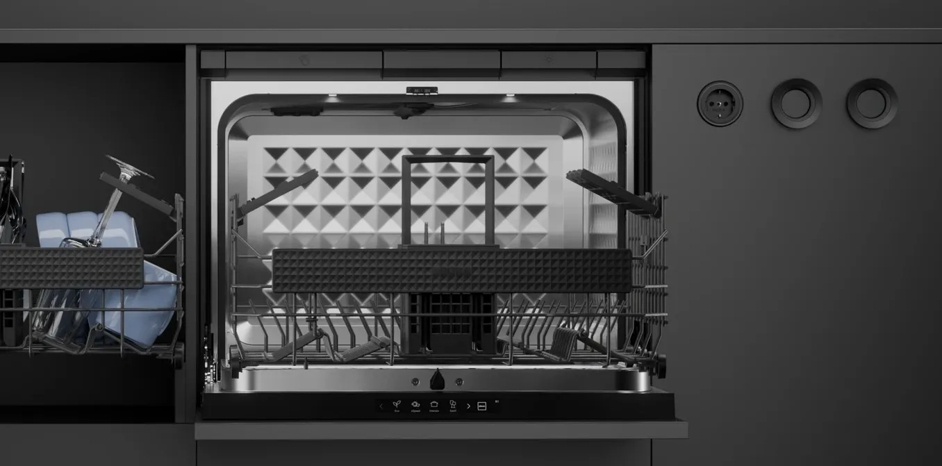 Open BORA Dish dishwasher built into a dark kitchen